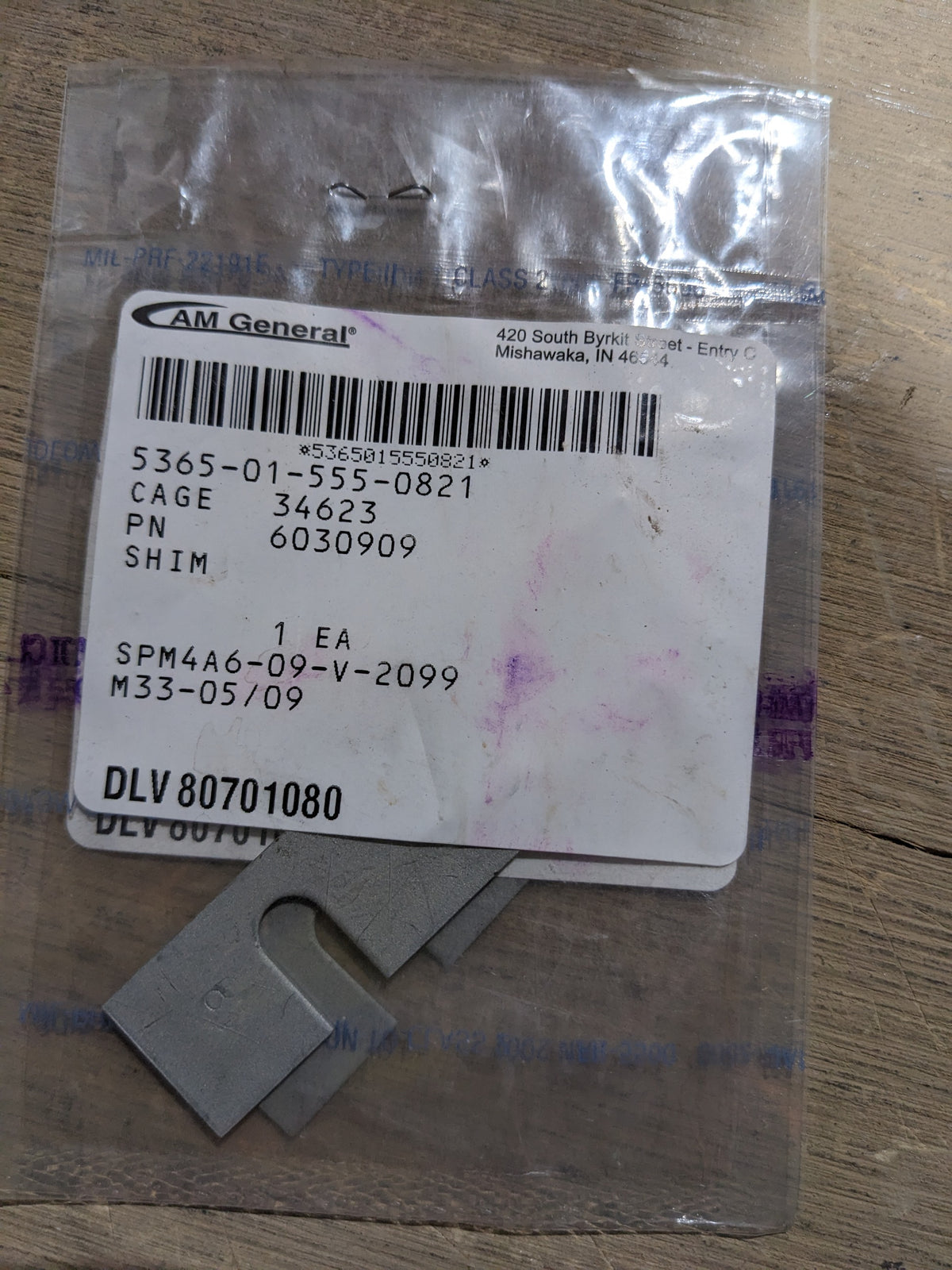 AM General 6030909 Dovetail Shim - NSN 5365-01-555-0821 - inventory label