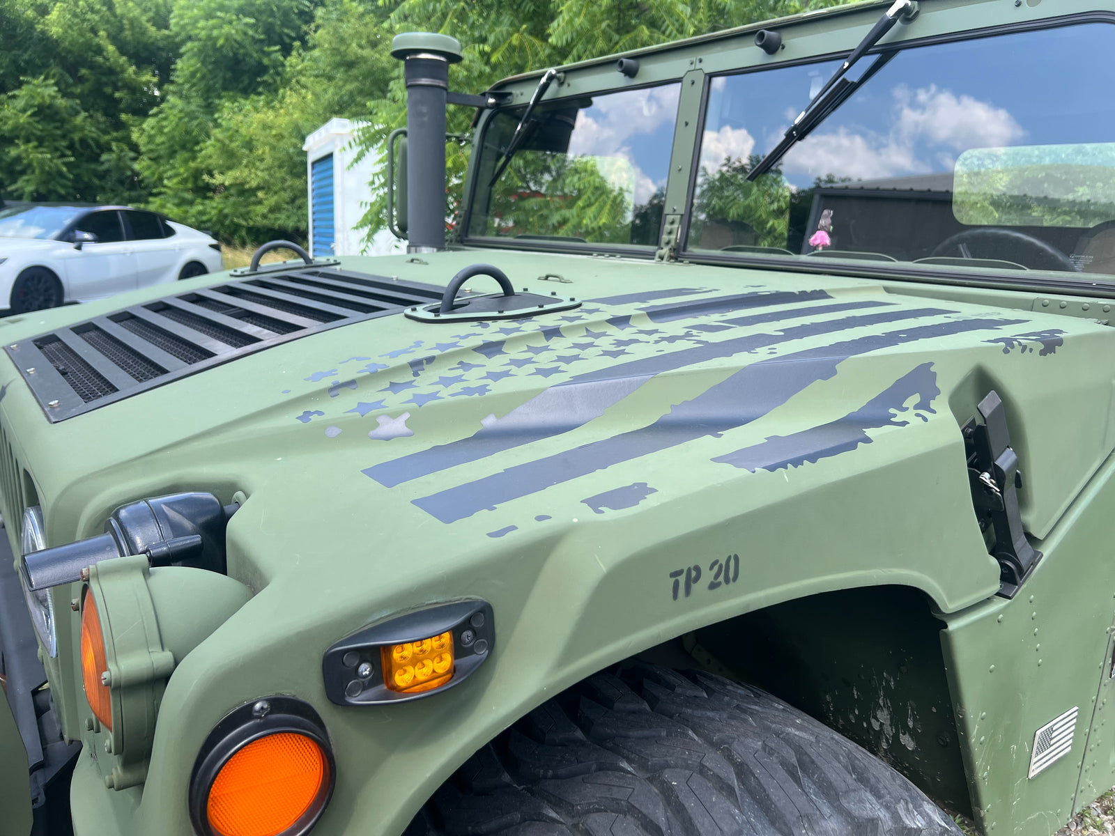Front fender and hood detail of a rebuilt HMMWV, bumper number TP 20
