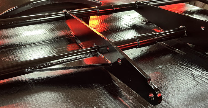 Freshly painted soft-top bow frames laid out after finishing