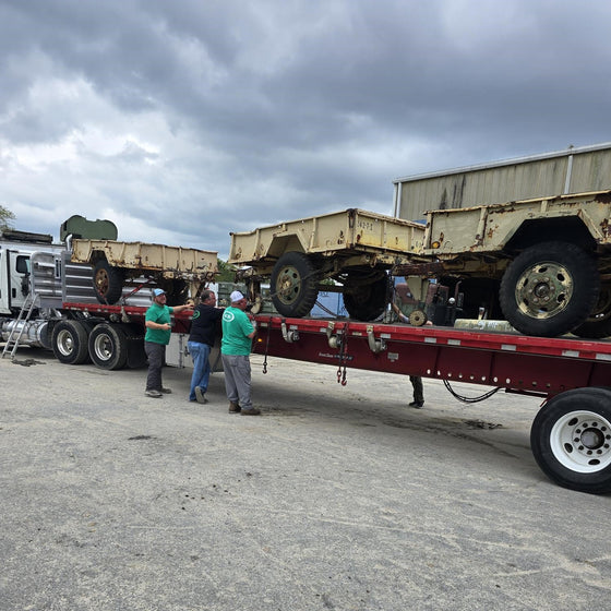 Winch trailer being loaded onto a flatbed