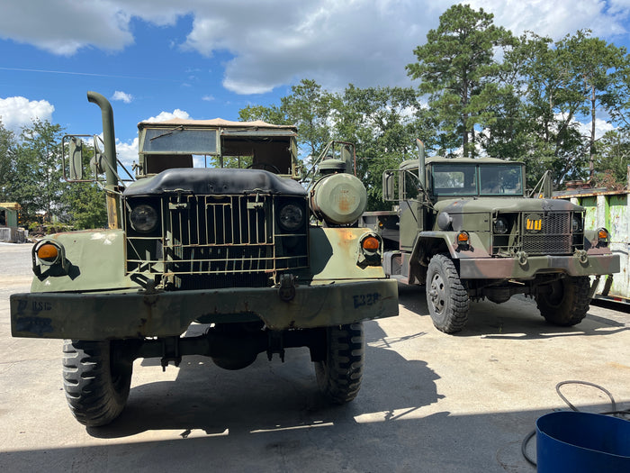 A line of military cargo trucks in the SECO yard